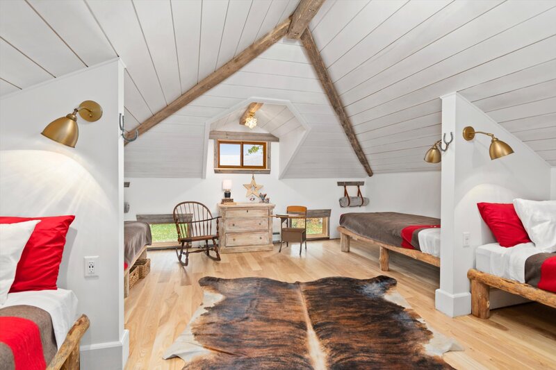 Sophisticated farmhouse decor in this bedroom perfect for kids with four single beds.